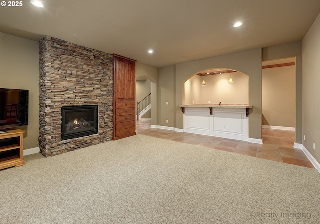 unfurnished living room with light colored carpet and a fireplace