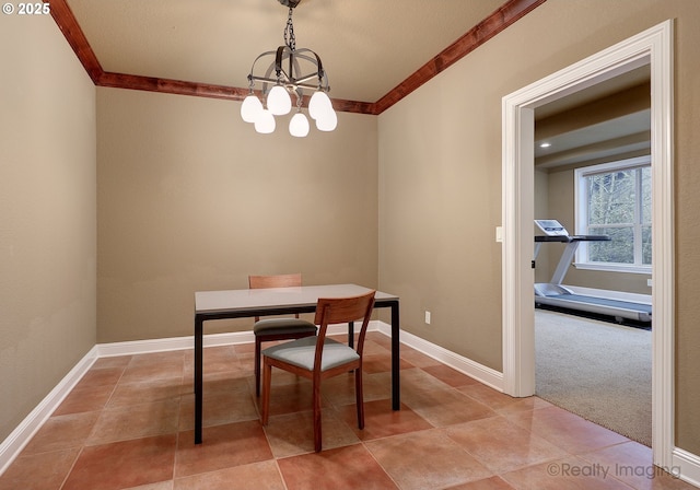 dining space with an inviting chandelier, crown molding, and carpet floors