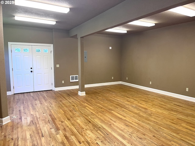 foyer featuring hardwood / wood-style floors and a textured ceiling