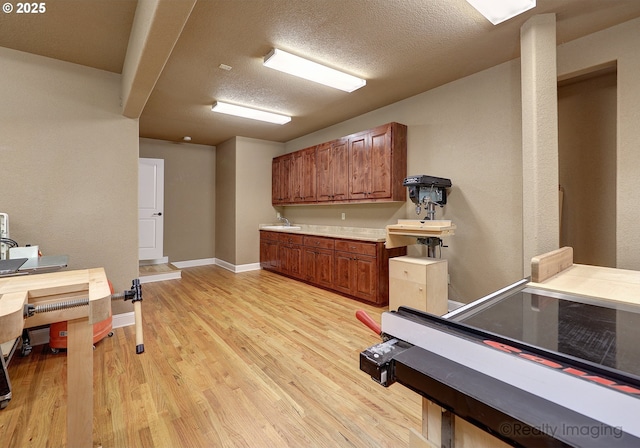 interior space with light hardwood / wood-style floors and a textured ceiling