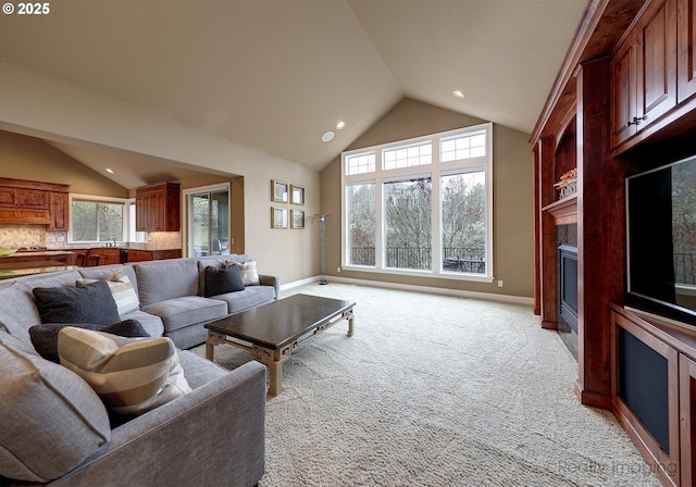 living room with high vaulted ceiling and light colored carpet