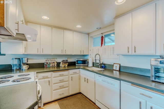 12520 SW Prince Albert St, King City, OR 97224 - kitchen with white appliances, recessed lighting, under cabinet range hood, white cabinetry, and dark countertops