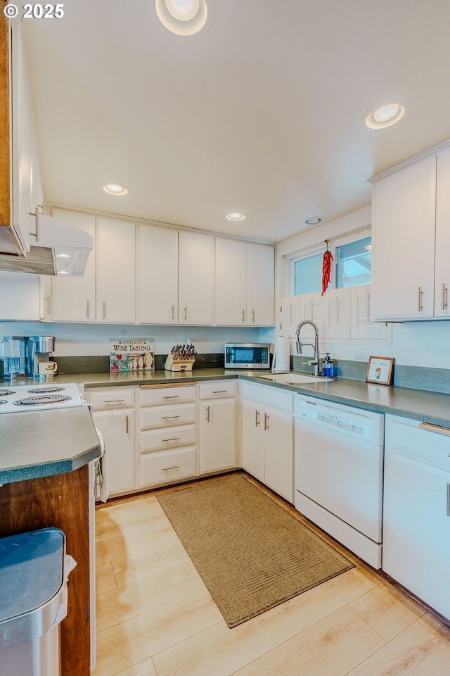 12520 SW Prince Albert St, King City, OR 97224 - kitchen featuring white dishwasher, stainless steel microwave, white cabinetry, recessed lighting, and light wood-style floors