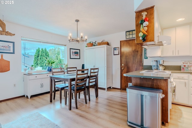 12520 SW Prince Albert St, King City, OR 97224 - dining area with a chandelier and light wood-style floors