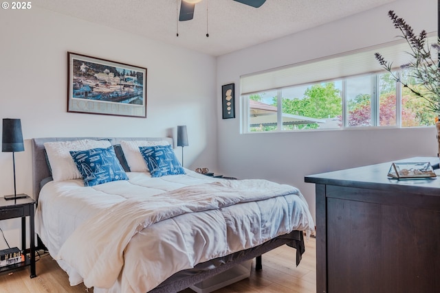 12520 SW Prince Albert St, King City, OR 97224 - bedroom with light wood-style floors, a textured ceiling, and a ceiling fan