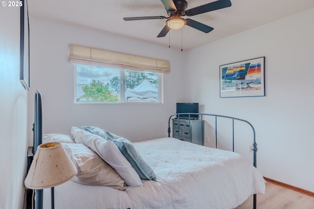 12520 SW Prince Albert St, King City, OR 97224 - bedroom featuring wood finished floors and a ceiling fan