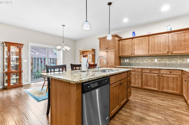 2741 25th Pl, Forest Grove, OR 97116 - kitchen with stainless steel dishwasher, a sink, a kitchen breakfast bar, wood finished floors, and pendant lighting