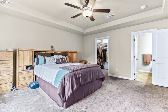 2741 25th Pl, Forest Grove, OR 97116 - carpeted bedroom featuring a walk in closet, a raised ceiling, a closet, baseboards, and ensuite bath