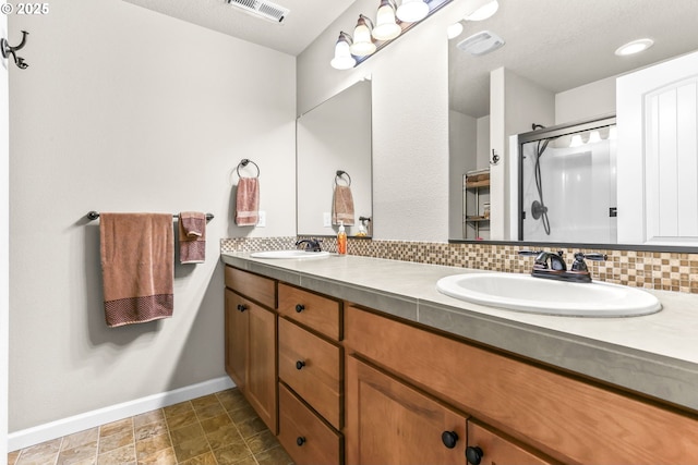 2741 25th Pl, Forest Grove, OR 97116 - full bathroom with baseboards, double vanity, a shower stall, and backsplash