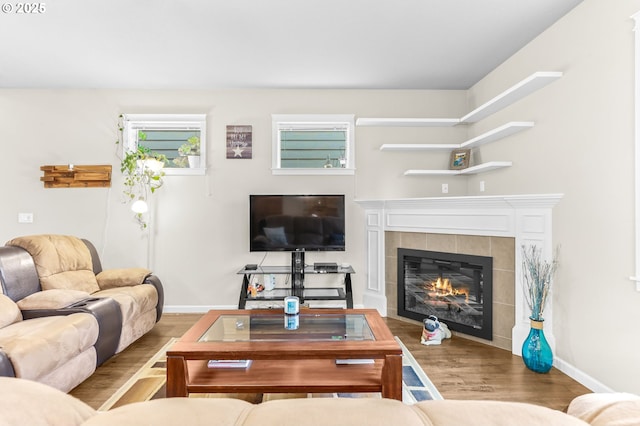 2741 25th Pl, Forest Grove, OR 97116 - living area featuring wood finished floors, a tile fireplace, and baseboards