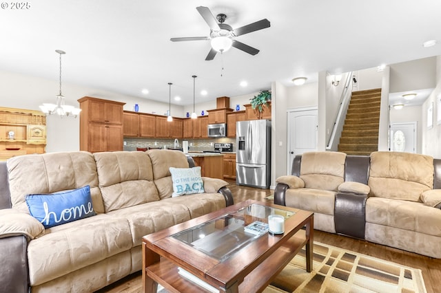 2741 25th Pl, Forest Grove, OR 97116 - living room with light wood finished floors, ceiling fan, a chandelier, stairs, and recessed lighting