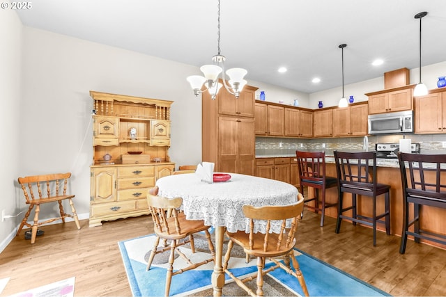 2741 25th Pl, Forest Grove, OR 97116 - dining space featuring light wood-type flooring, a chandelier, recessed lighting, and baseboards