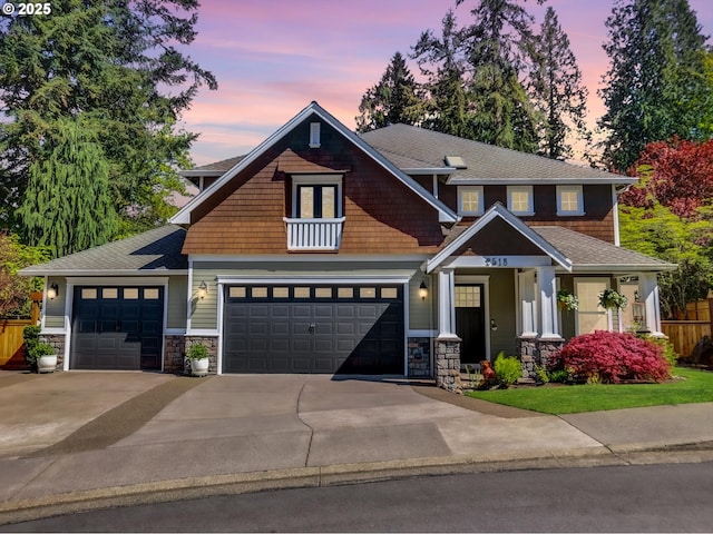 craftsman inspired home with an attached garage, a porch, stone siding, and concrete driveway