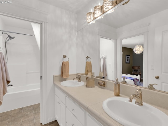 ensuite bathroom with a sink, bathing tub / shower combination, ensuite bath, and double vanity