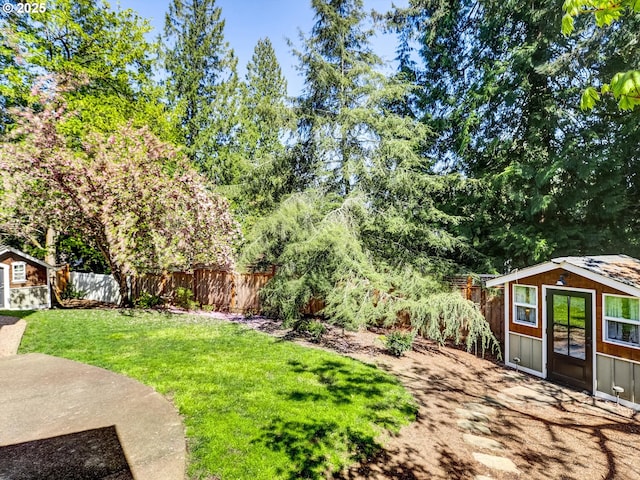 view of yard with an outdoor structure and a fenced backyard