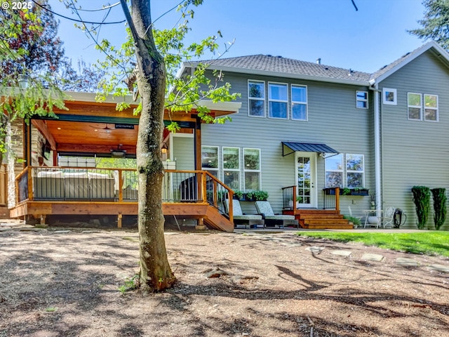 back of property featuring a deck