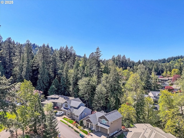 bird's eye view featuring a residential view and a wooded view