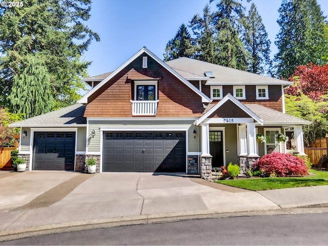 craftsman-style home with fence, a porch, driveway, and stone siding