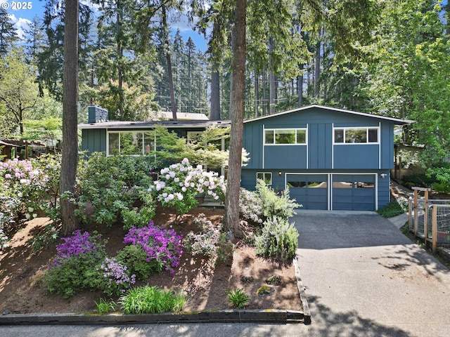 536 Kingswood Ave, Eugene, OR 97405 - view of front facade with a garage, board and batten siding, and driveway