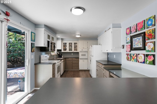 536 Kingswood Ave, Eugene, OR 97405 - kitchen featuring white appliances, glass insert cabinets, white cabinetry, a sink, and dark wood finished floors