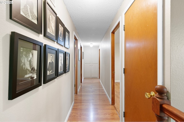 536 Kingswood Ave, Eugene, OR 97405 - hall with light wood-type flooring, a textured ceiling, and baseboards