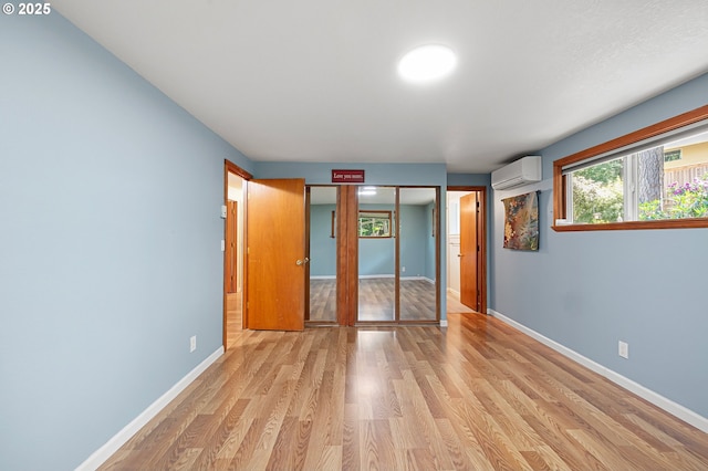 536 Kingswood Ave, Eugene, OR 97405 - unfurnished bedroom with light wood-style floors, baseboards, and a wall mounted AC