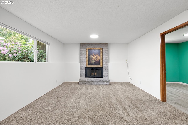 536 Kingswood Ave, Eugene, OR 97405 - unfurnished living room featuring carpet flooring, a textured ceiling, and a fireplace