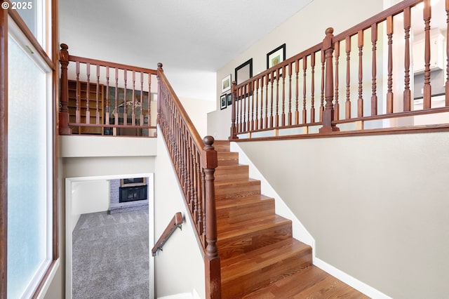 536 Kingswood Ave, Eugene, OR 97405 - stairs featuring a glass covered fireplace, baseboards, and wood finished floors
