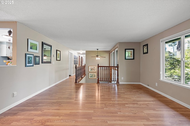 536 Kingswood Ave, Eugene, OR 97405 - spare room with a textured ceiling, ceiling fan, baseboards, and light wood-style flooring