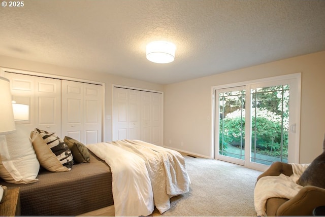 2440 SW Burbank Ave, Portland, OR 97225 - bedroom with access to exterior, multiple closets, a textured ceiling, and light carpet