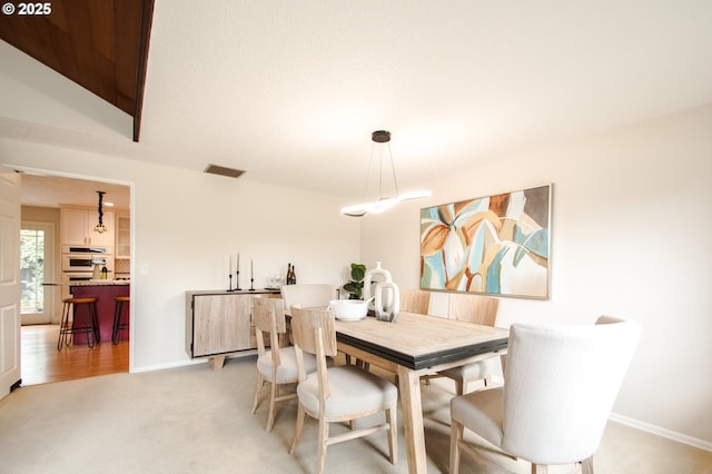2440 SW Burbank Ave, Portland, OR 97225 - dining room featuring baseboards and light colored carpet