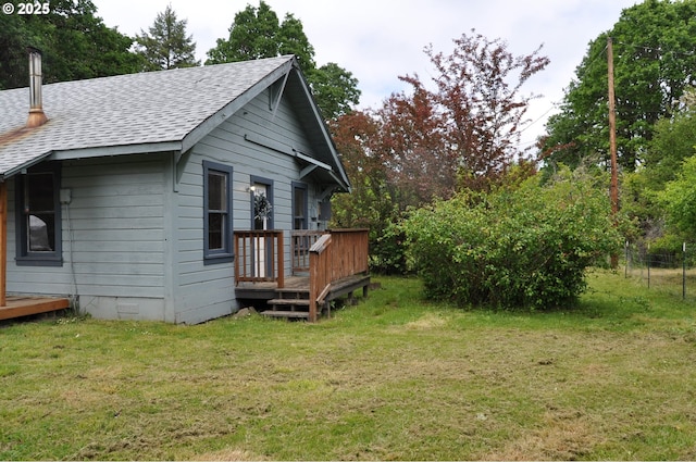87624 Territorial Rd, Veneta, OR 97487 - view of home's exterior featuring a shingled roof, a deck, and a lawn