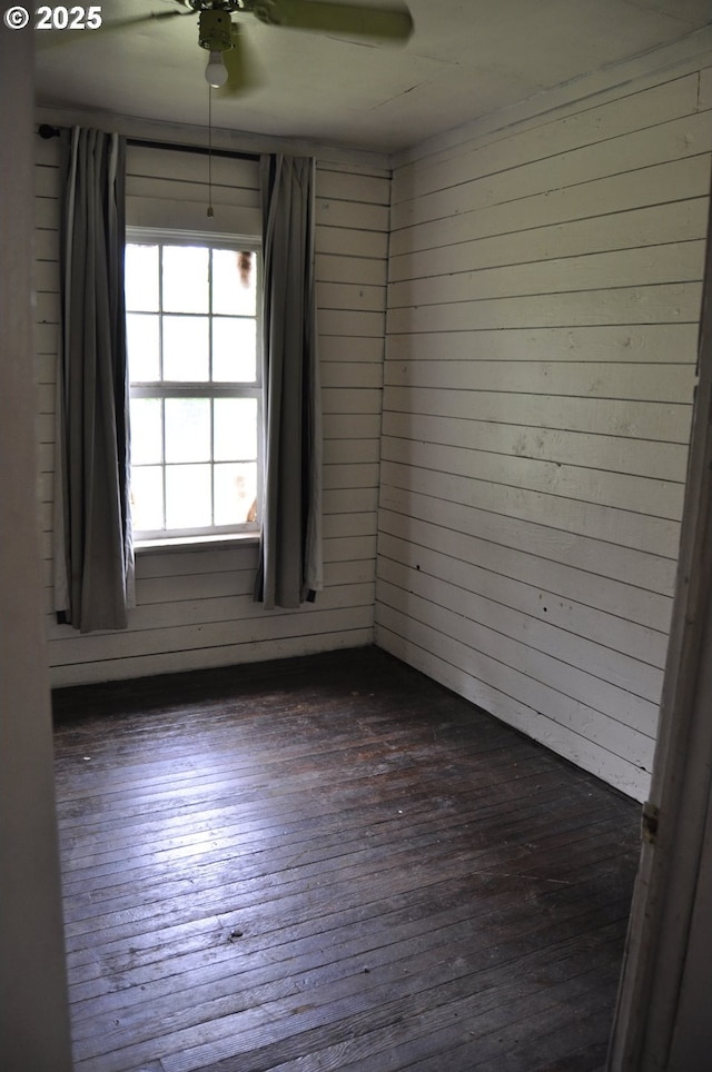 87624 Territorial Rd, Veneta, OR 97487 - spare room with dark wood-style flooring, a ceiling fan, and wood walls
