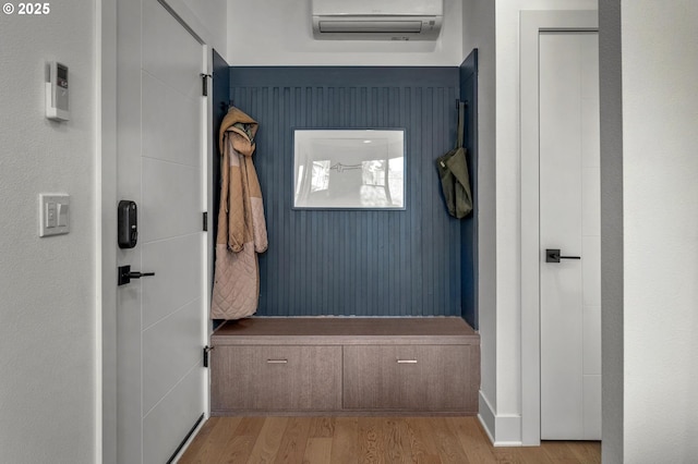 interior space featuring a wall mounted air conditioner and wood finished floors