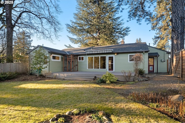 back of house with a yard and a deck