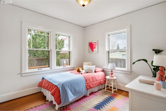 bedroom featuring light wood-type flooring and baseboards