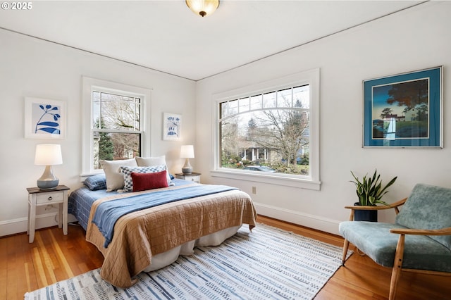 bedroom with wood finished floors and baseboards