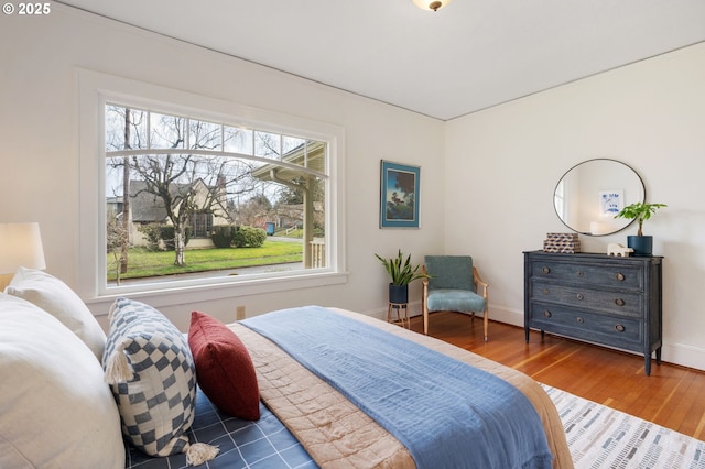 bedroom with wood finished floors and baseboards