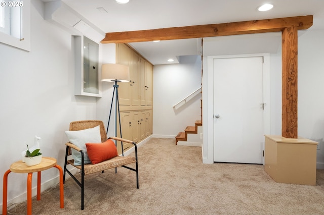 sitting room featuring stairway, recessed lighting, beamed ceiling, and light carpet