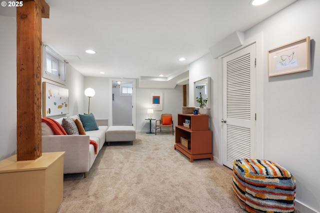 carpeted living area with recessed lighting and baseboards