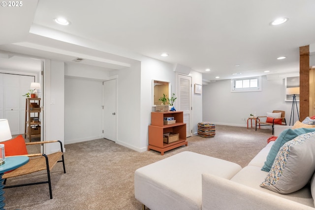 living room with recessed lighting, visible vents, baseboards, and light colored carpet