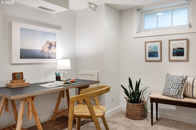 carpeted office space with baseboards and visible vents