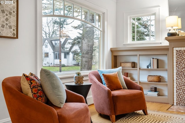 sitting room featuring plenty of natural light and wood finished floors