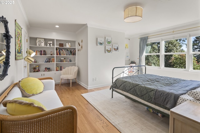 bedroom with crown molding, light wood finished floors, baseboards, and recessed lighting