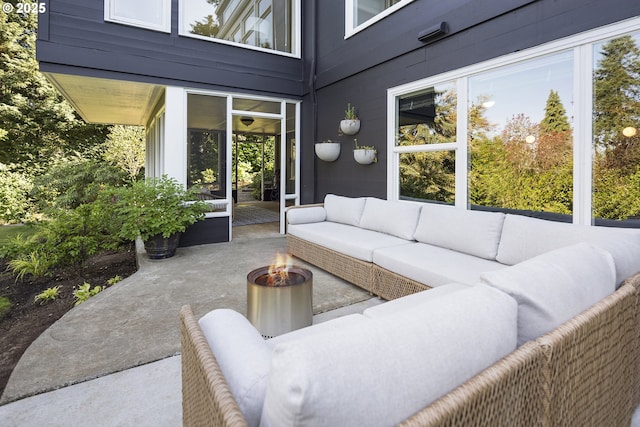 view of patio / terrace featuring an outdoor living space with a fire pit