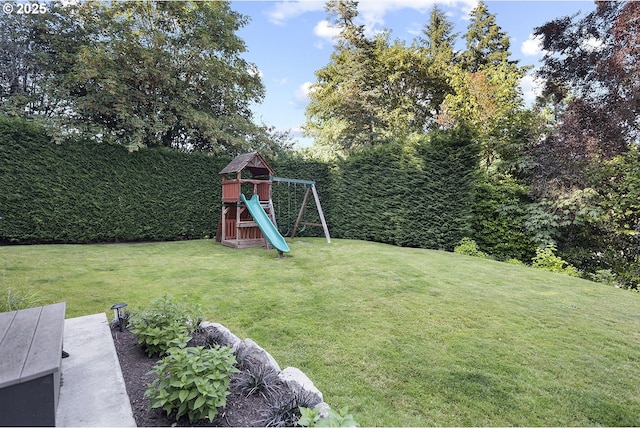 view of grassy yard with a playground