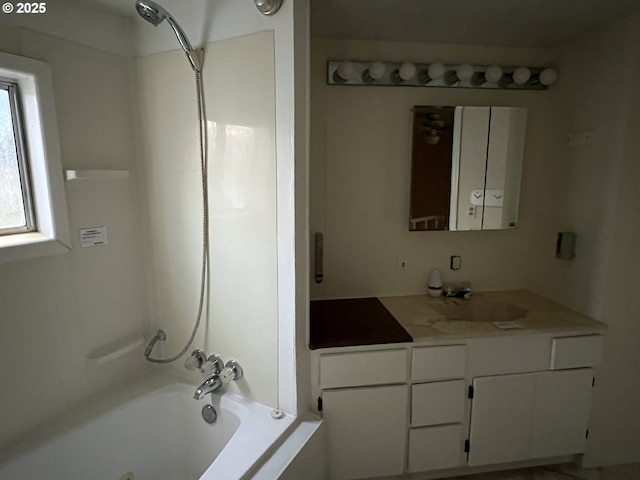 bathroom featuring vanity and  shower combination