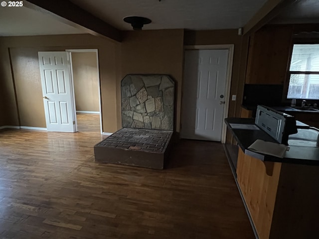 kitchen with dark hardwood / wood-style flooring and beam ceiling