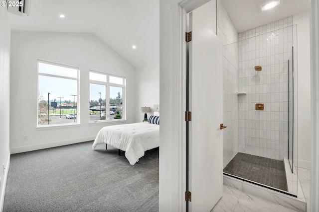 bathroom featuring a tile shower and lofted ceiling