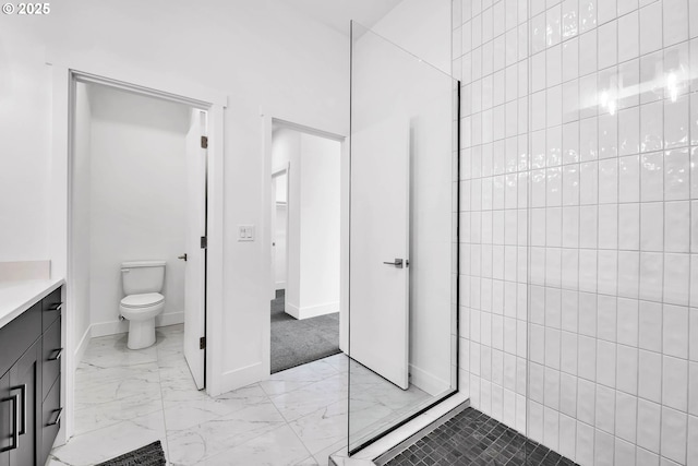 bathroom with walk in shower, vanity, and toilet